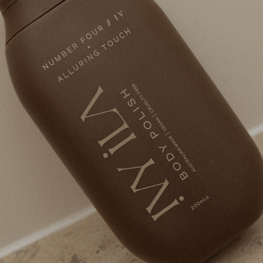 Brown bottle of IVY ILA body polish on a neutral background