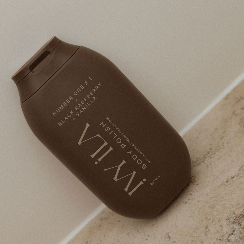 Brown body polish container with 'IVY' branding on a neutral background