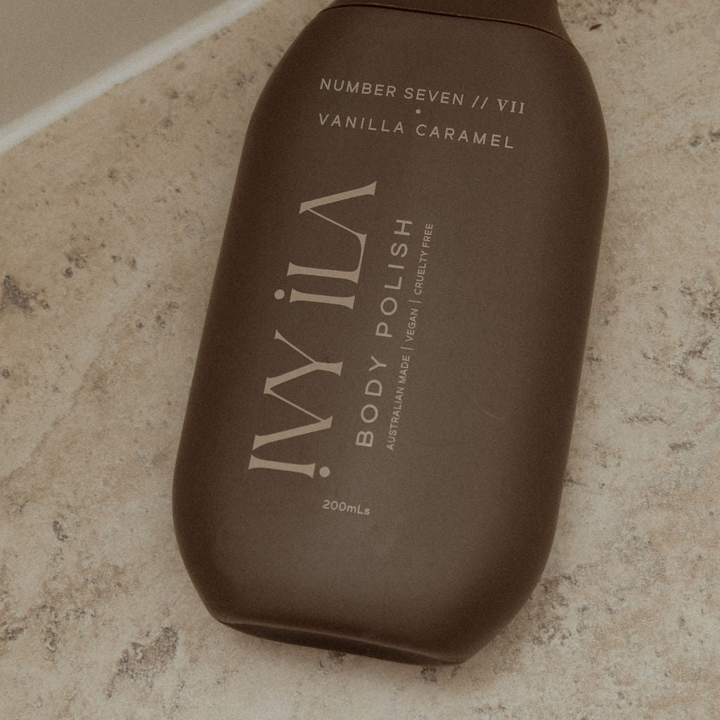 Brown bottle of IViLA body polish on a marble surface
