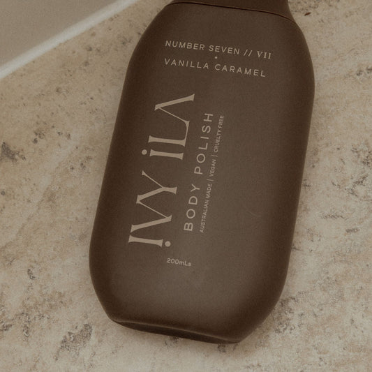 Brown bottle of IViLA body polish on a marble surface