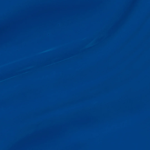 A close-up of draped royal blue fabric with soft folds and a subtle sheen.