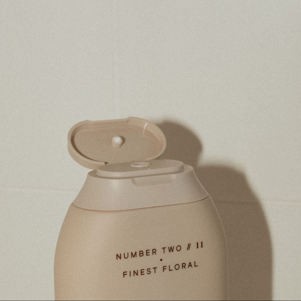 Beige bottle labeled 'Number Two Finest Floral' on a plain background