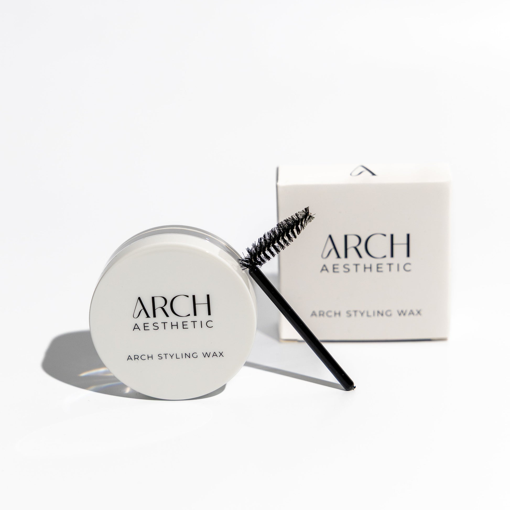 Arch Aesthetic styling wax with a brush on a white background