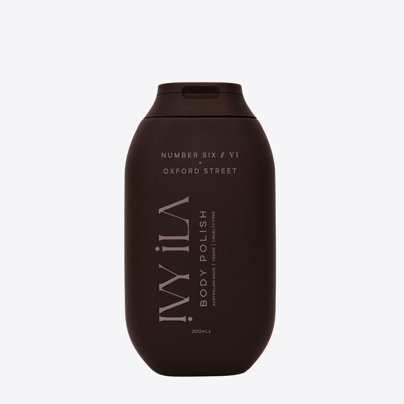 Brown bottle of ILA body polish on a white background