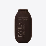 Brown bottle of Vanilla Caramel body polish on a white background
