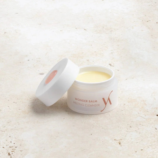 Jar of Wonder Balm on a light textured surface