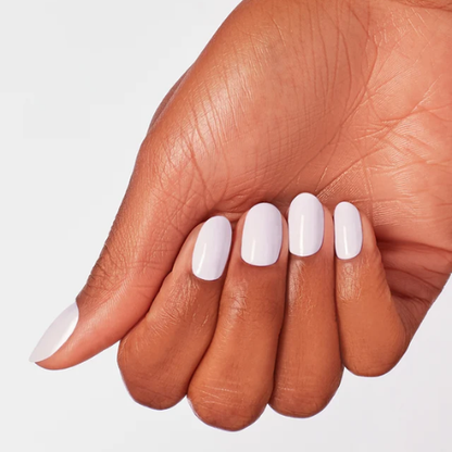 A close-up of a hand with a manicure featuring a glossy, solid pale lavender nail polish on a clean white background.