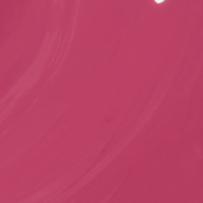 A close-up of a solid pink color with subtle texture and a small bright highlight near the top right corner.