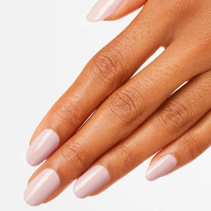 A close-up of a hand with neatly manicured nails painted in a glossy, pale pink color, set against a clean white background.