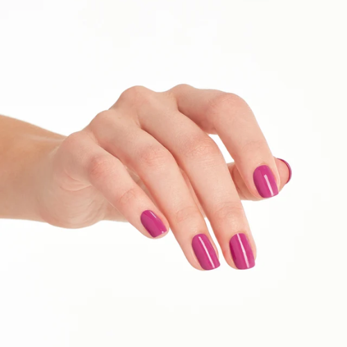 A close-up of a hand with neatly manicured nails painted in a glossy magenta pink color, set against a plain white background.