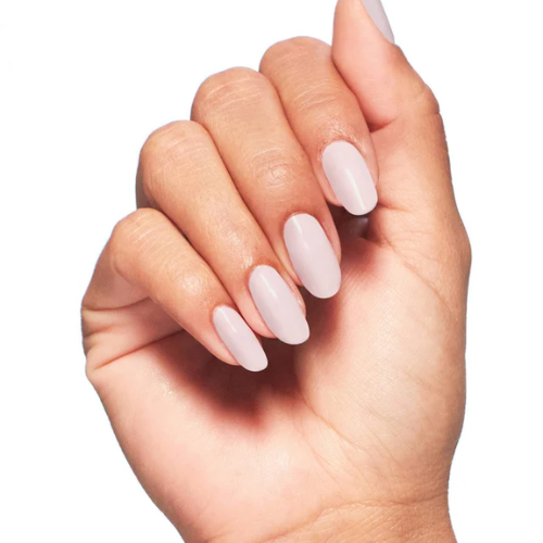 A close-up of a hand with a glossy, pale pink almond-shaped manicure against a solid white background.